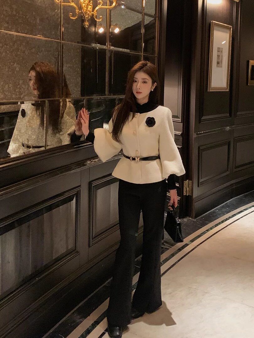 Black and white elegant outfit worn by a model indoors