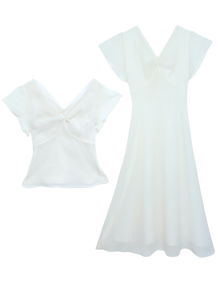 White sheer feminine dress and matching top on a plain background