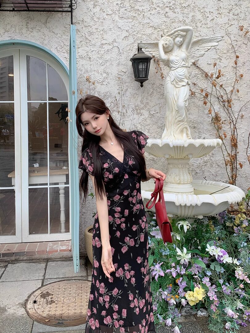 Woman wearing a black floral maxi dress outdoors