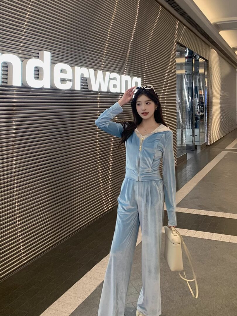 Light blue velour two-piece outfit worn by a model indoors