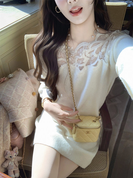 Woman wearing a white lace-trim knit dress with a small yellow quilted mini bag