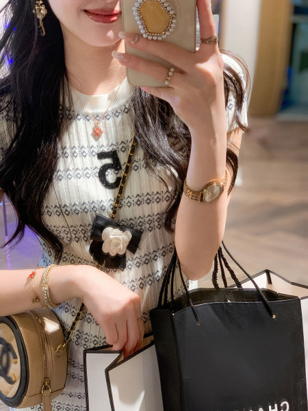 White patterned knit top worn by a model