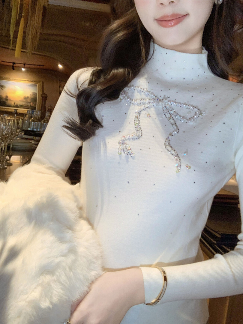 Woman wearing a white embellished long-sleeve top