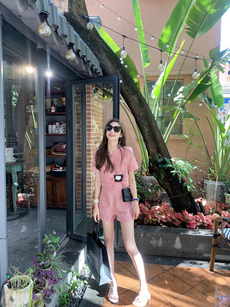 Woman wearing a pink short-sleeve romper outdoors