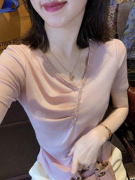 Pink short-sleeve V-neck knit top worn by a model