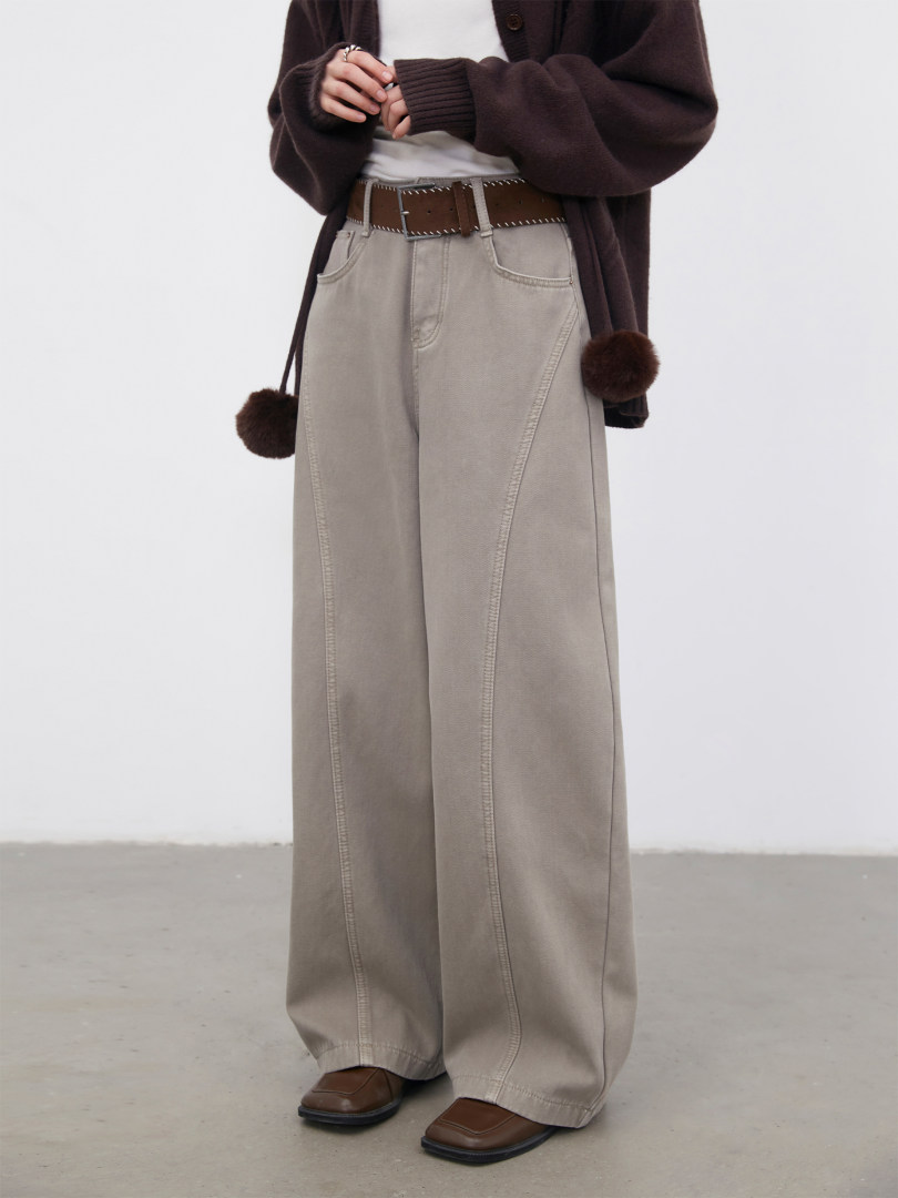 Model wearing wide-leg beige pants with a brown sweater and belt