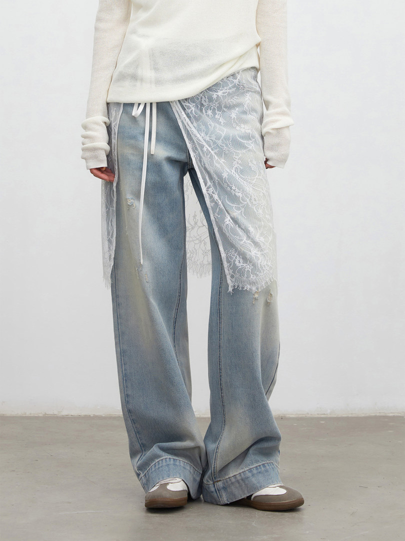 Model wearing light-wash wide-leg distressed jeans with lace overlay