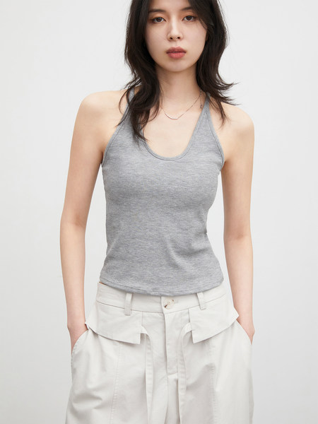 Model wearing a gray ribbed halter tank top with white pants