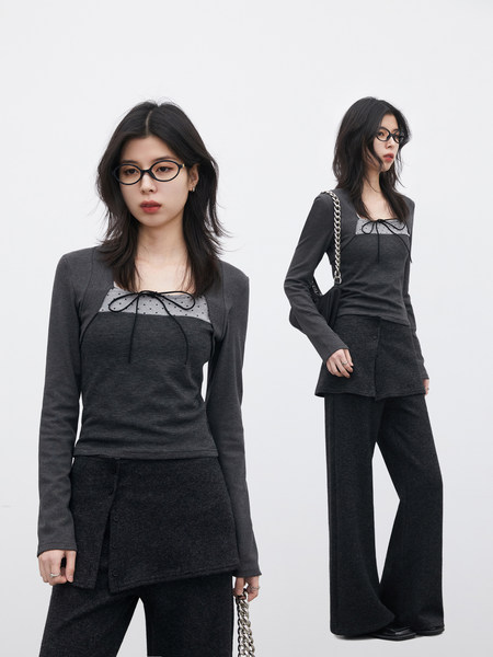 Model wearing a dark gray layered long-sleeve top with matching wide-leg pants