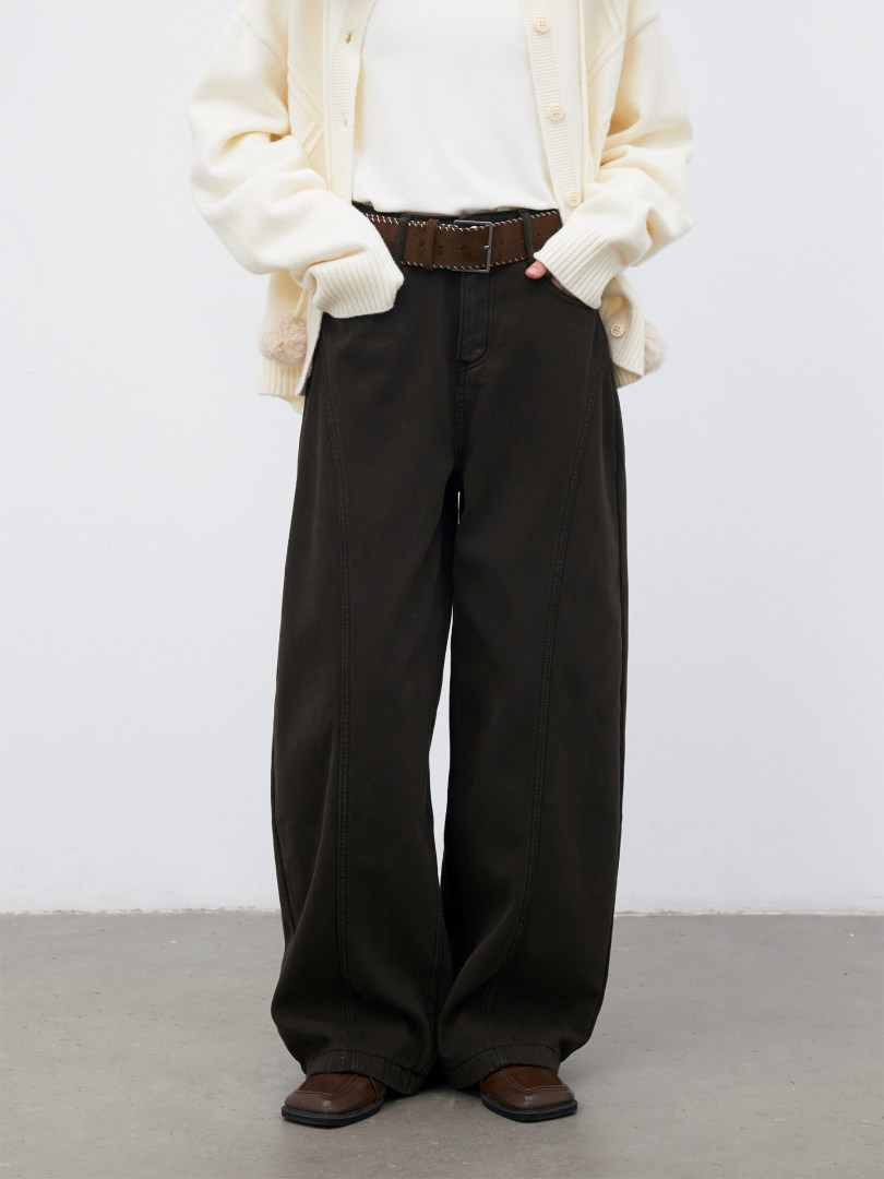 Model wearing a cream cardigan with black wide-leg pants and brown loafers