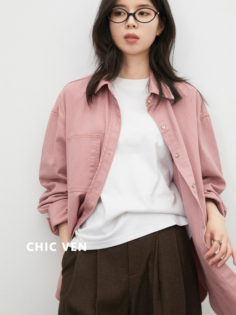 Model wearing a pink oversized button-up shirt over a white tee