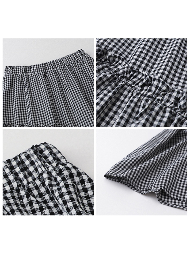Black-and-white gingham garment laid flat with elastic waistband and gathered fabric
