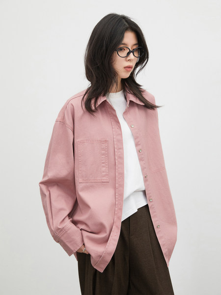 Model wearing a pink oversized button-up shirt with a patch pocket