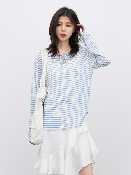 Model wearing a blue-and-white striped long-sleeve top with a white ruffled skirt