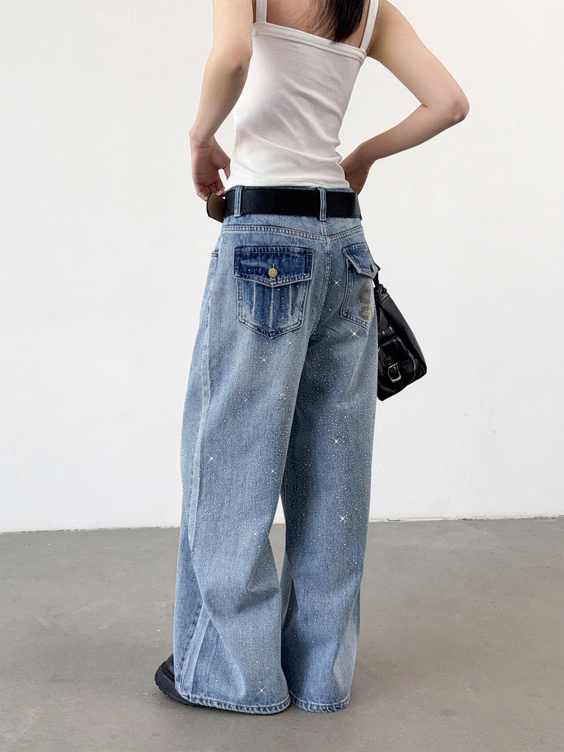 Wide-leg sparkly blue denim jeans worn by a model