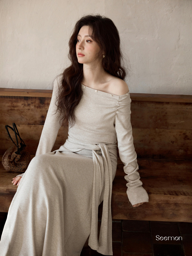 Model wearing a beige off-shoulder long-sleeve knit dress