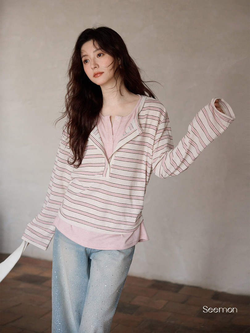 Model wearing a pink striped long-sleeve loungewear set with light blue pants