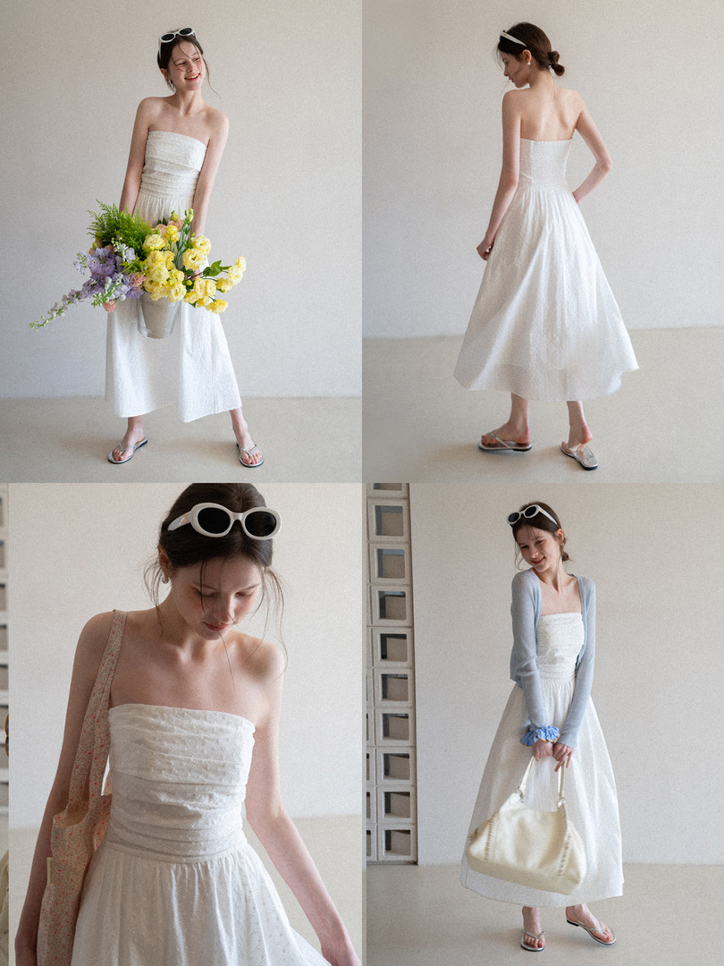 White strapless midi dress worn by a model in a studio setting