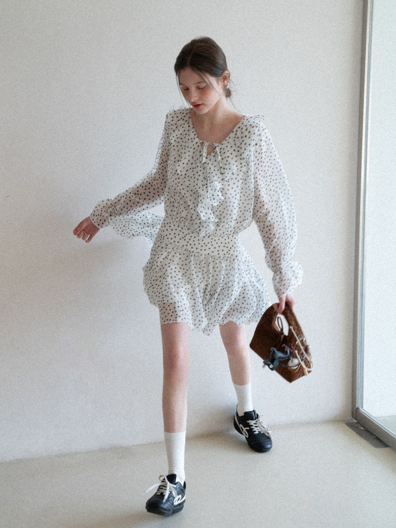 Model wearing a sheer white polka dot long-sleeve matching set