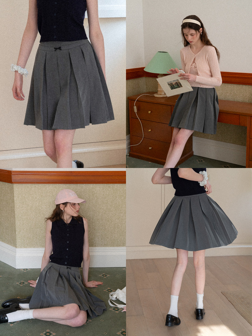 Gray pleated skirt worn by a model in multiple outfit photos