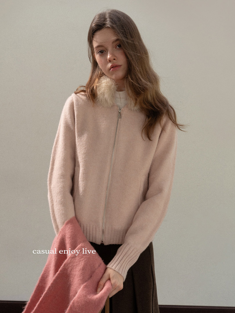 Pink zip-up cardigan worn by a model