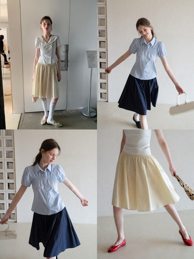 Model wearing a pastel short-sleeve blouse and flowing midi skirt in multiple colorways
