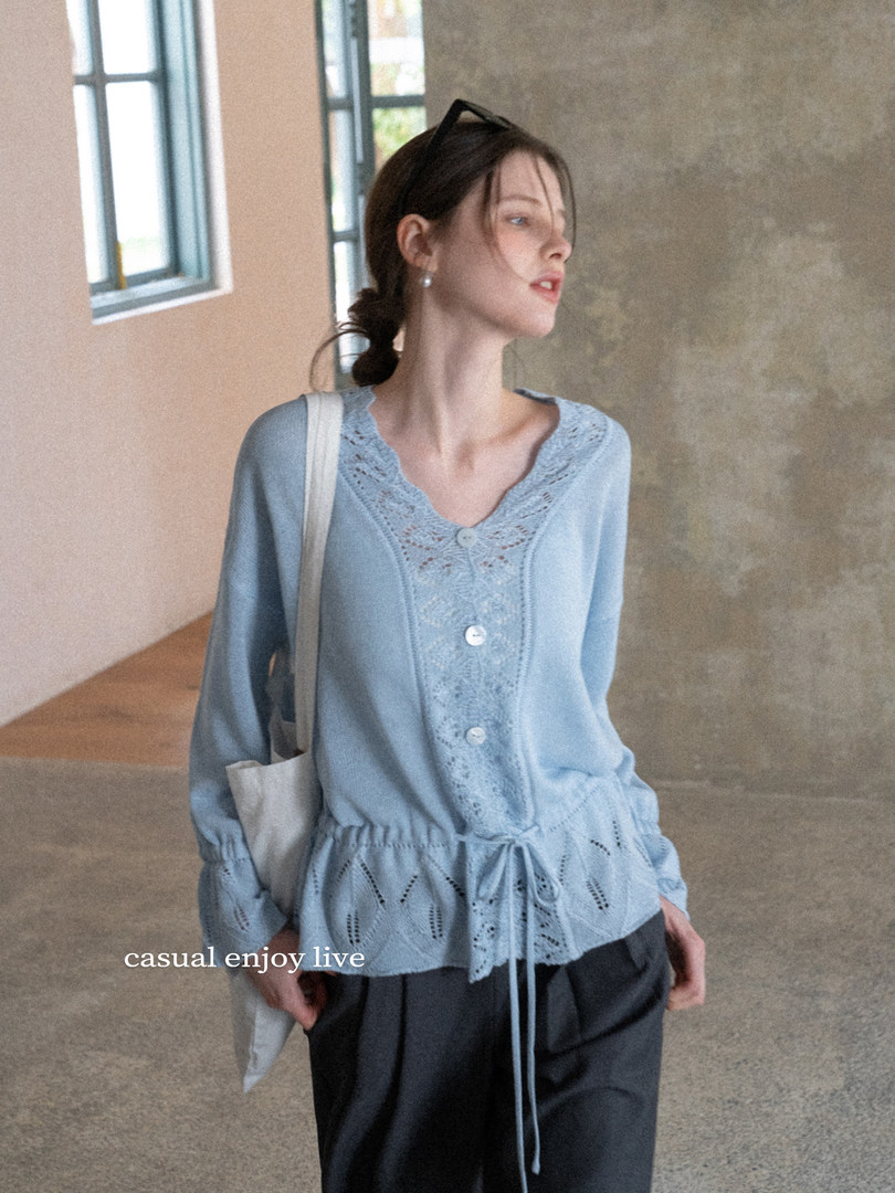 Light blue lace-trimmed blouse worn by a model