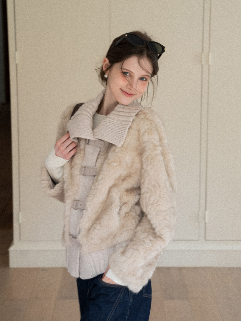Beige faux fur coat worn by a model