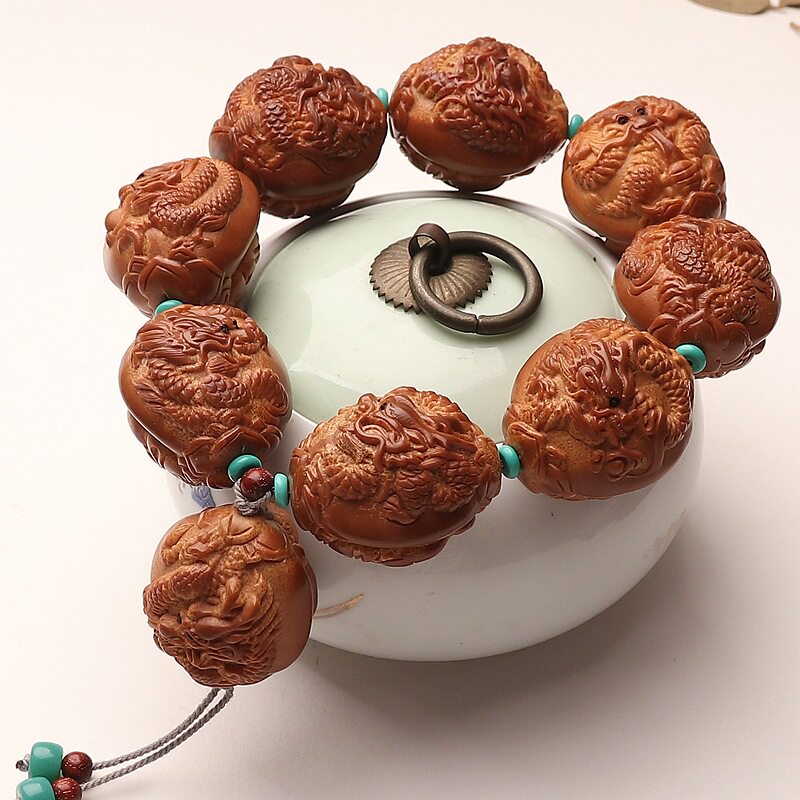 巴西橄榄核大籽手把件浮雕九龙献瑞手持八大财神文玩手串双面雕刻