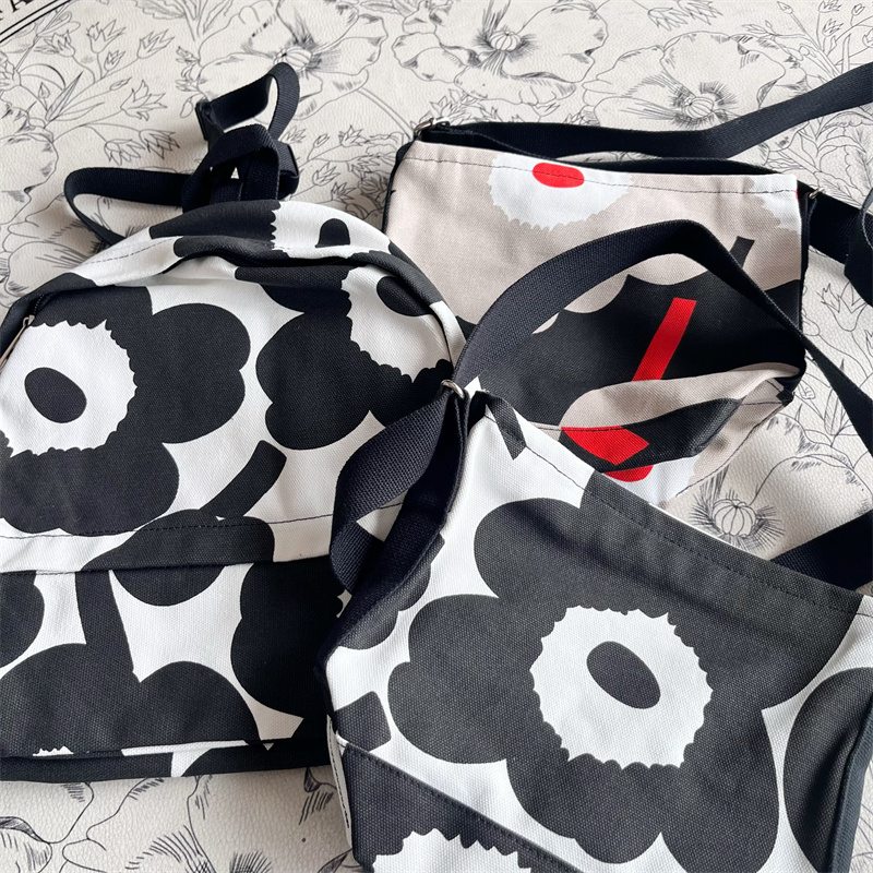 M家北欧太阳花小众设计黑白印花帆布单肩斜跨水桶饺子包双肩包