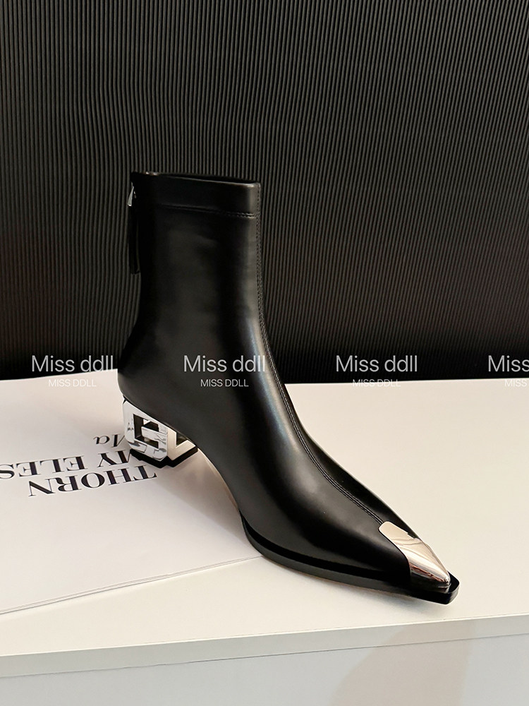Black pointed-toe ankle boot with metallic toe cap and sculpted heel