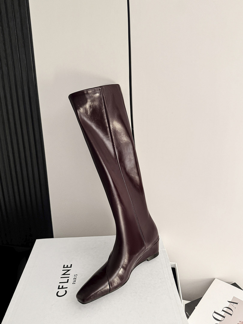 Burgundy knee-high leather boot on a display box