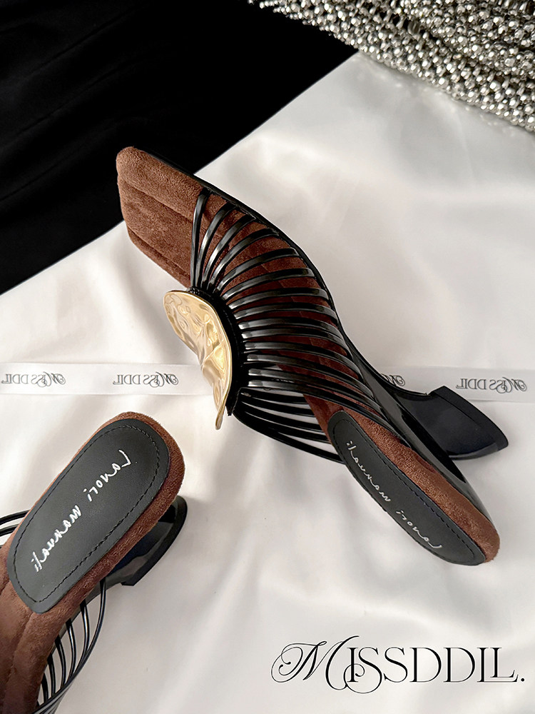 Black high-heeled strappy sandals with brown accents and gold decorative detail