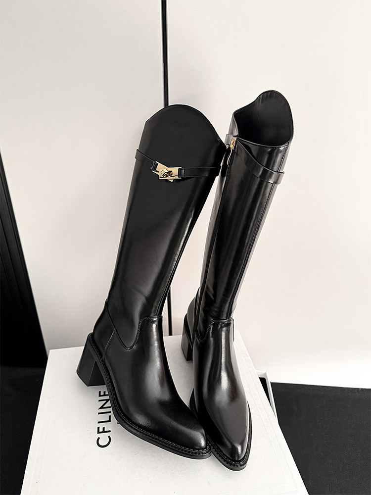 Black knee-high leather boots with block heels on a display box