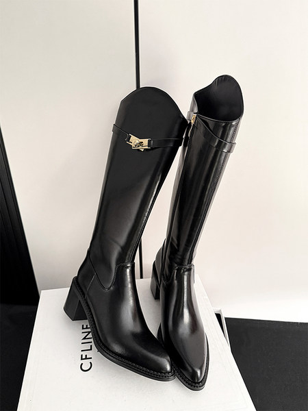 Black knee-high leather boots with block heels on a display box