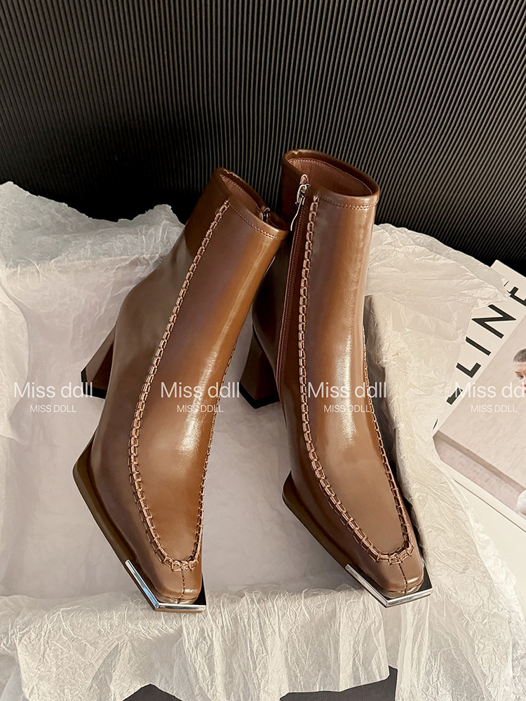 Brown leather ankle boots with square heels on display
