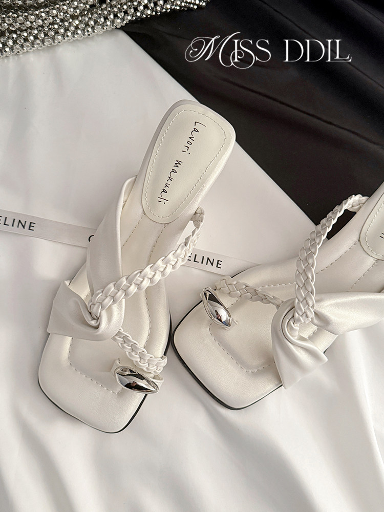 White braided-strap heeled sandals on a satin background