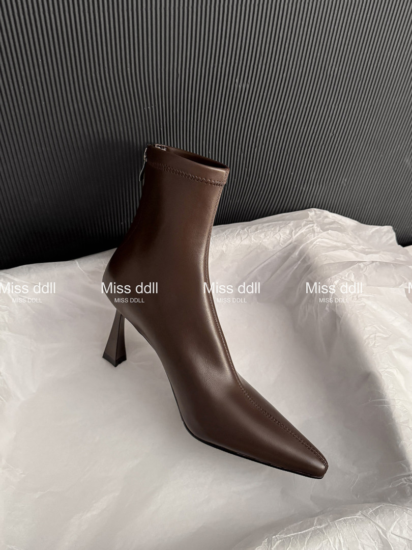 Brown pointed-toe ankle boot with a high sculpted heel