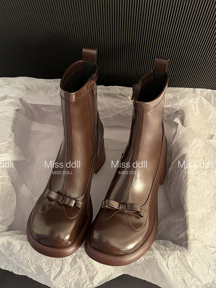 Brown leather ankle boots with decorative bows
