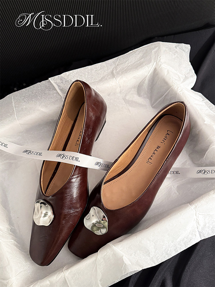 Pair of brown pointed leather flats with metallic embellishment