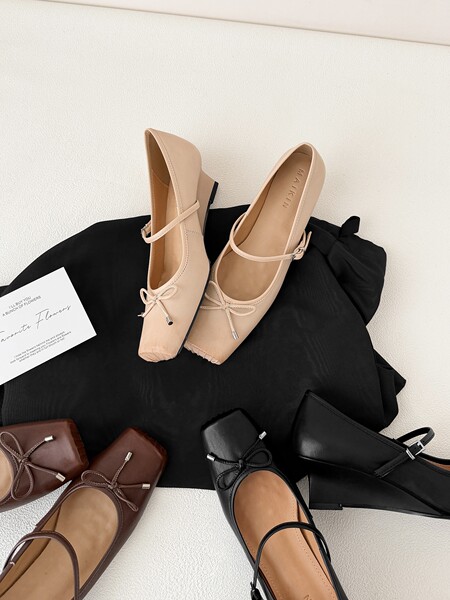 Assorted Mary Jane ballet flats in multiple colors displayed on a surface