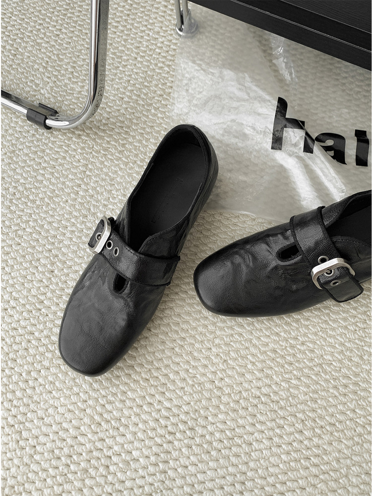 Black Mary Jane-style flats with buckle strap