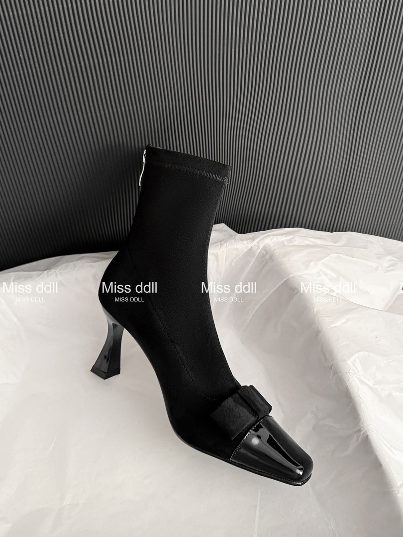 Black pointed-toe ankle boot with a sculptural heel