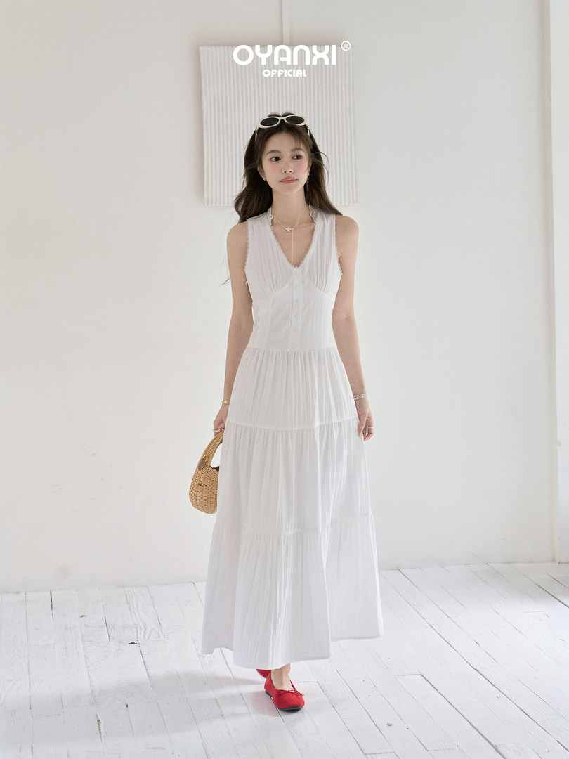White sleeveless tiered maxi dress worn by a model
