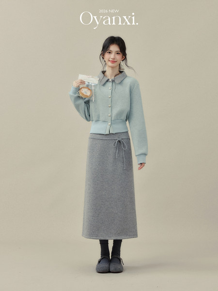 Model wearing a light blue cardigan and gray knit skirt set