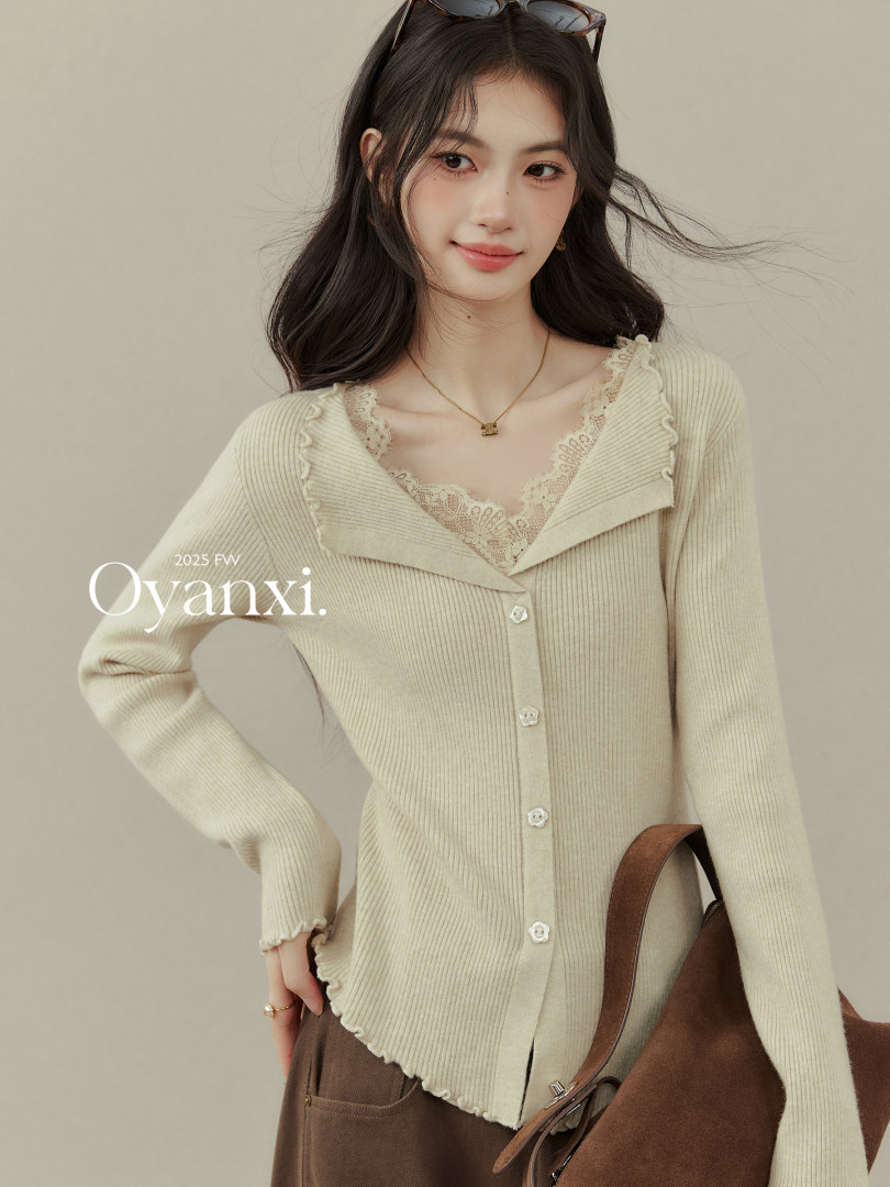 Beige lace-trim knit cardigan worn by a model with a brown shoulder bag