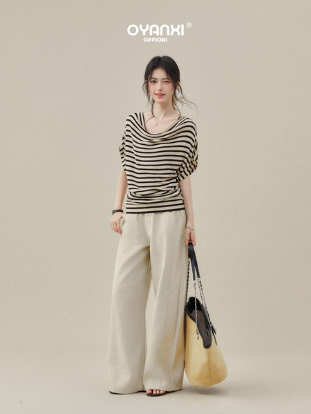 Model wearing a striped short-sleeve top with wide-leg cream pants