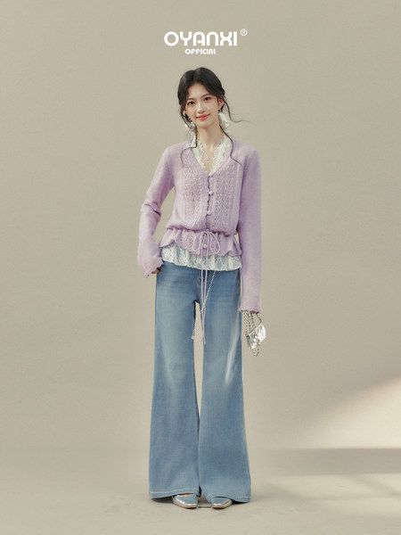 Model wearing a lavender cardigan with lace trim over wide-leg blue jeans