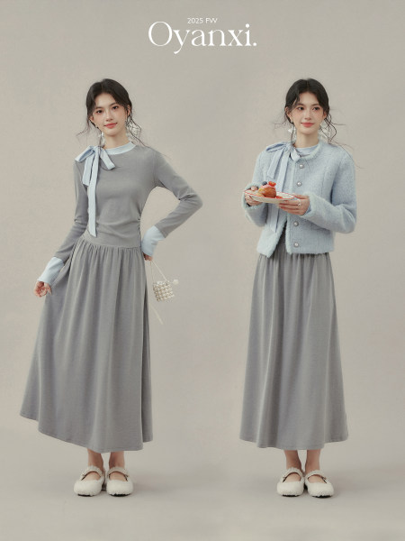 Two women modeling a gray long-sleeve dress with a light blue cardigan and ribbon detail