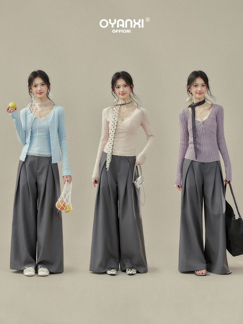Three models wearing pastel long-sleeve tops with wide-leg gray pants